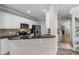 Modern kitchen featuring white cabinets, granite countertops, stainless steel appliances, and stylish fixtures at 9670 Cypress Pine St, Orlando, FL 32827