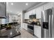 Well-equipped kitchen with stainless steel appliances, granite countertops, and sleek white cabinetry at 9670 Cypress Pine St, Orlando, FL 32827