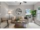 Cozy living room with neutral tones, comfortable seating, and natural light from a large window at 9670 Cypress Pine St, Orlando, FL 32827