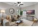 Comfortable living room with modern furnishings, neutral colors, and abundant natural light at 9670 Cypress Pine St, Orlando, FL 32827