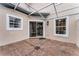 Enclosed patio featuring sliding glass door, brick flooring, and an overhead trellis at 9670 Cypress Pine St, Orlando, FL 32827