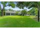 Large backyard showcasing the home's exterior, screened porch, pool area, and lush landscaping at 9743 Chestnut Ridge Dr, Windermere, FL 34786