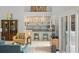 Stylish wet bar features a bar top, shelving, and seating in this open-concept living space at 9743 Chestnut Ridge Dr, Windermere, FL 34786