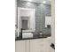 Stylish powder room featuring mosaic tile wall, vessel sink, black granite countertop and vanity at 9743 Chestnut Ridge Dr, Windermere, FL 34786