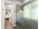 Bathroom showcasing a glass shower door, tiled floor, and an ensuite entryway to primary bedroom at 9743 Chestnut Ridge Dr, Windermere, FL 34786