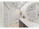 Bright bathroom with marble countertop, dual shower heads, a glass door and a storage unit at 9743 Chestnut Ridge Dr, Windermere, FL 34786