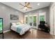 Bedroom with hardwood floors, ceiling fan, double doors to outdoor patio, and workspace at 9743 Chestnut Ridge Dr, Windermere, FL 34786