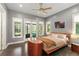 Bedroom featuring hardwood floors, modern furniture, and ample natural light with screened-in patio access at 9743 Chestnut Ridge Dr, Windermere, FL 34786