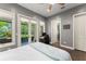 Bedroom featuring hardwood floors, a ceiling fan, and double doors to a screened porch at 9743 Chestnut Ridge Dr, Windermere, FL 34786