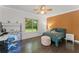 Bright bedroom with hardwood floors, modern lighting and large windows overlooking the backyard at 9743 Chestnut Ridge Dr, Windermere, FL 34786