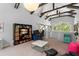 Bright bonus room featuring modern furniture, high ceilings, exposed beams, and a large window with a view to the outdoors at 9743 Chestnut Ridge Dr, Windermere, FL 34786