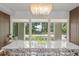 Dining area boasting modern lighting, sleek furniture, and large windows showcasing serene outdoor views at 9743 Chestnut Ridge Dr, Windermere, FL 34786