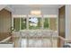 Well-lit dining room featuring hardwood floors, modern chandelier, and views of lush outdoor scenery at 9743 Chestnut Ridge Dr, Windermere, FL 34786
