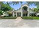 Stunning two-story home boasting a brick driveway, lush landscaping and charming architectural details at 9743 Chestnut Ridge Dr, Windermere, FL 34786