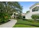 A charming home featuring lush landscaping, a brick driveway, and mature trees at 9743 Chestnut Ridge Dr, Windermere, FL 34786