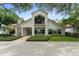 Beautifully landscaped front yard and brick driveway leading to a modern two-story home with large windows at 9743 Chestnut Ridge Dr, Windermere, FL 34786