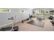 Spacious home gym with high ceilings, natural light, and equipped with workout equipment at 9743 Chestnut Ridge Dr, Windermere, FL 34786