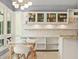 Bright kitchen with white cabinetry, stainless appliances, granite counters, and an adjacent breakfast area with backyard views at 9743 Chestnut Ridge Dr, Windermere, FL 34786