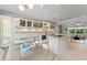 Bright kitchen with stainless steel appliances, an island, granite countertops, and a breakfast area with backyard views at 9743 Chestnut Ridge Dr, Windermere, FL 34786