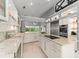 Bright kitchen with stainless steel appliances, granite countertops, and an island cooktop, overlooking the backyard at 9743 Chestnut Ridge Dr, Windermere, FL 34786