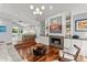 Stylish living area featuring a stone fireplace, built-in shelving, and an open floor plan to the kitchen at 9743 Chestnut Ridge Dr, Windermere, FL 34786