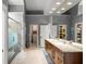 Main bathroom featuring a glass shower, granite countertops with double sinks, and a walk-in closet at 9743 Chestnut Ridge Dr, Windermere, FL 34786