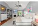 Bright primary bedroom features a ceiling fan, an ensuite bathroom, and ample closet space at 9743 Chestnut Ridge Dr, Windermere, FL 34786