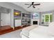 Spacious main bedroom with built-in shelves, fireplace, ceiling fan and a sitting area with view to the outdoors at 9743 Chestnut Ridge Dr, Windermere, FL 34786