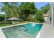 Backyard pool with lounge chairs and umbrella is surrounded by lush greenery at 9743 Chestnut Ridge Dr, Windermere, FL 34786