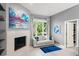 Sitting room with a fireplace, large art piece and a bright window with a view to the outdoors at 9743 Chestnut Ridge Dr, Windermere, FL 34786
