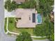 Overhead view of home with screened-in pool, patio and mature trees at 10080 Cove Lake Dr, Orlando, FL 32836