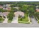 Aerial view of property showcasing mature trees, landscaping, and well-manicured lawn at 10080 Cove Lake Dr, Orlando, FL 32836