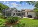 Spacious backyard featuring a screened pool, patio, and well-manicured lawn at 10080 Cove Lake Dr, Orlando, FL 32836