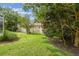 Well-maintained backyard with lush landscaping and mature trees at 10080 Cove Lake Dr, Orlando, FL 32836