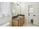Bathroom featuring a granite-topped vanity, large mirror, tile flooring, and exterior access at 10080 Cove Lake Dr, Orlando, FL 32836
