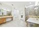 Spacious bathroom with double vanity, walk-in shower, and lots of bright light at 10080 Cove Lake Dr, Orlando, FL 32836