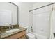 Bright bathroom features a granite vanity and shower-tub combo with neutral tile at 10080 Cove Lake Dr, Orlando, FL 32836