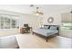 Bright bedroom with hardwood floors, a ceiling fan, and a work desk near the window at 10080 Cove Lake Dr, Orlando, FL 32836