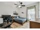 Bedroom with a ceiling fan, desk, and large window at 10080 Cove Lake Dr, Orlando, FL 32836