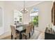 Open dining area with hardwood floors and views of the front yard at 10080 Cove Lake Dr, Orlando, FL 32836