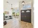Elegant entryway with high ceilings, decorative double doors, and light wood floors at 10080 Cove Lake Dr, Orlando, FL 32836