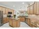 Spacious kitchen features an island, stainless steel appliances, and tile backsplash at 10080 Cove Lake Dr, Orlando, FL 32836