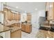 A spacious kitchen with an island, stainless steel appliances, and wooden cabinets for ample storage at 10080 Cove Lake Dr, Orlando, FL 32836