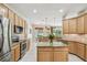 Well-lit kitchen with granite countertops, an island, and stainless-steel appliances at 10080 Cove Lake Dr, Orlando, FL 32836