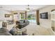 Relaxing living room with views of the pool, kitchen, and dining area, perfect for entertaining guests at 10080 Cove Lake Dr, Orlando, FL 32836