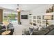 A cozy living room with a view of the pool, built-in shelving, and comfortable leather seating at 10080 Cove Lake Dr, Orlando, FL 32836