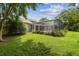 Exterior shot of a screened-in pool and patio area with a view of the backyard at 10080 Cove Lake Dr, Orlando, FL 32836