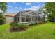 Screened-in pool and patio area with lush landscaping offering a private outdoor oasis at 10080 Cove Lake Dr, Orlando, FL 32836