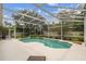 The screened pool is surrounded by lush landscaping, offering a private oasis at 10080 Cove Lake Dr, Orlando, FL 32836