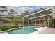 Relaxing screened-in pool with lush landscaping and a spacious patio area at 10080 Cove Lake Dr, Orlando, FL 32836